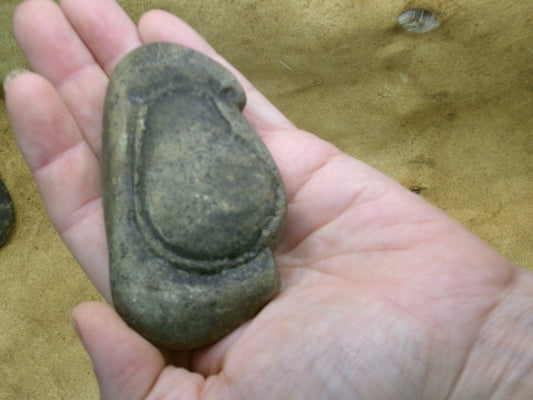 Egg face stone artifact